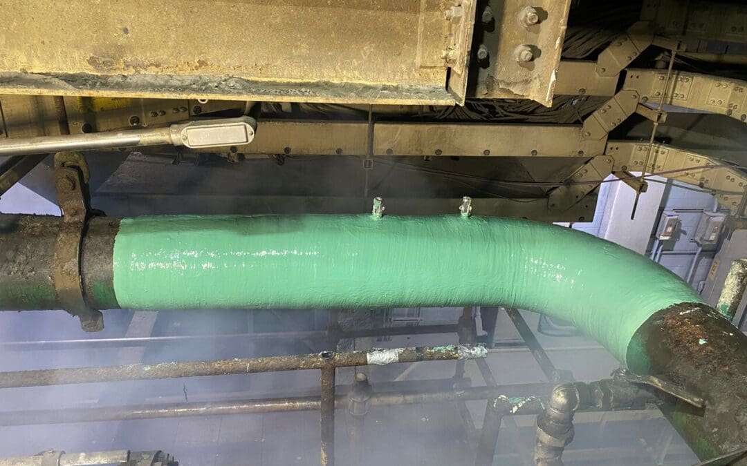 Repaired industrial pipeline reinforced with carbon fiber composite wrap, showing a clean, durable finish after repair to prevent leaks and corrosion.