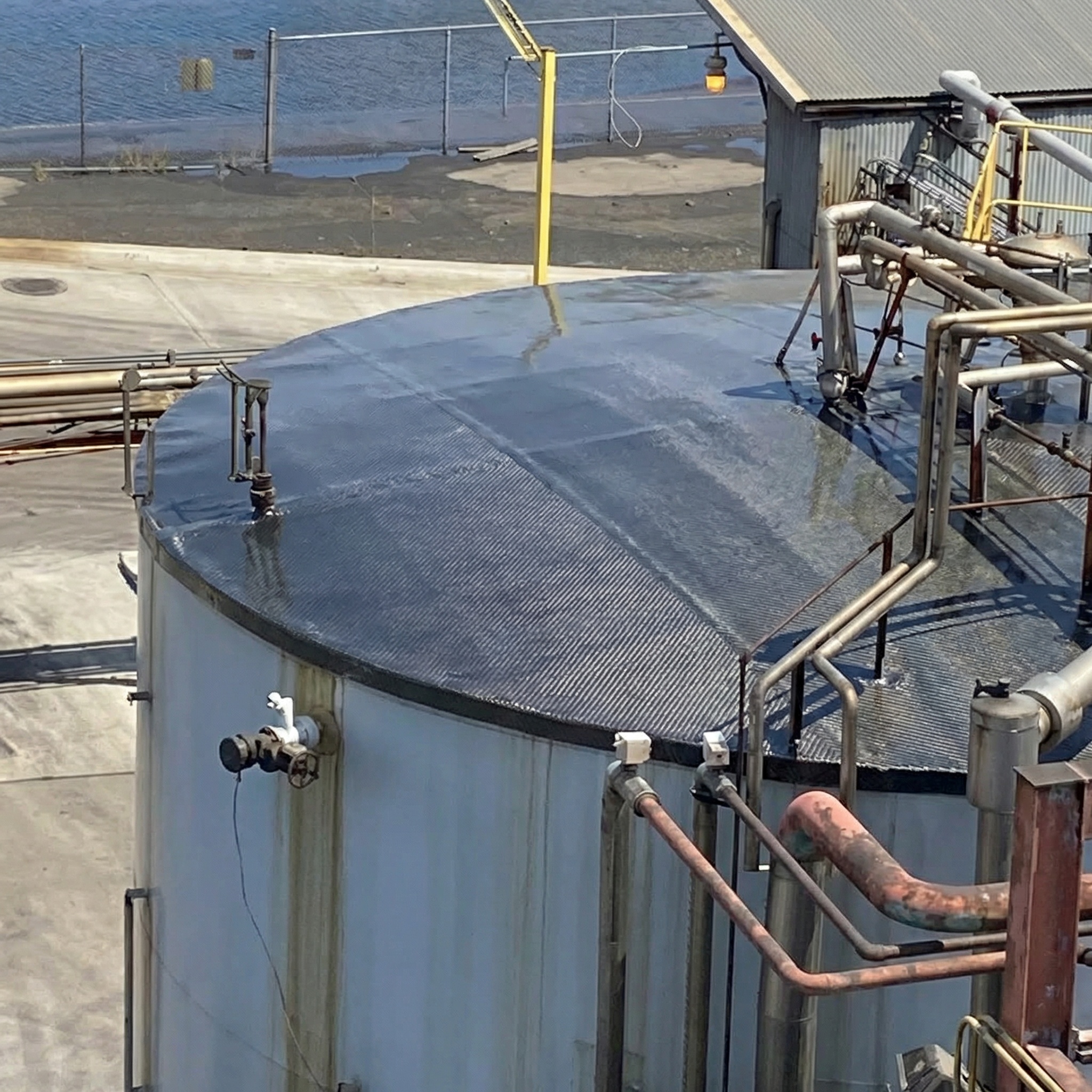 Tank exterior after composite wrap repair showing reinforced and restored structure