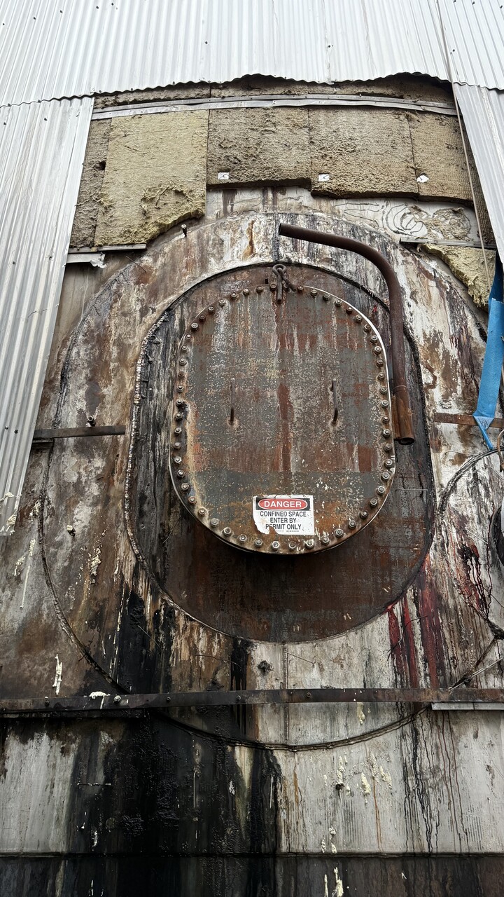 Industrial tank before composite repair showing deterioration